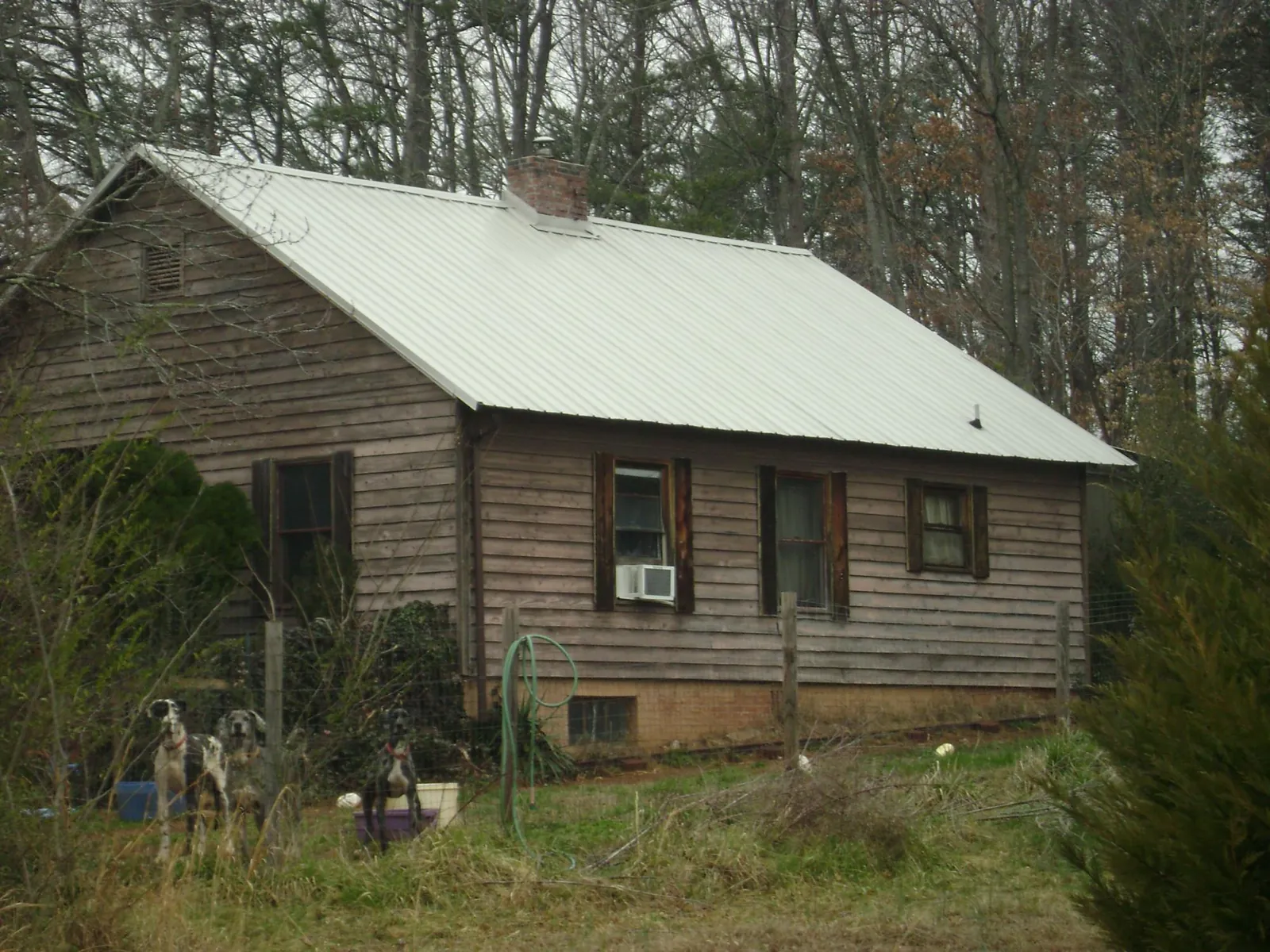 White metal roof on an old wood sided farmhouse, from a Metal Roof Installation job in Hayfield